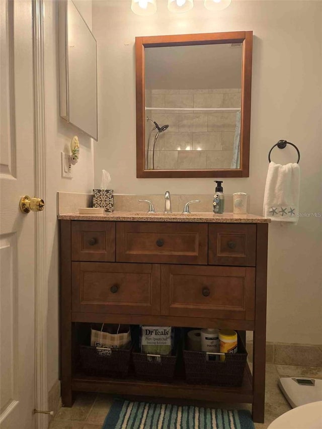 bathroom with walk in shower and vanity