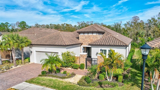 mediterranean / spanish house with a garage