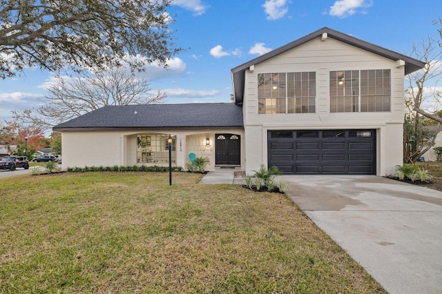 view of front of property with a garage and a front lawn