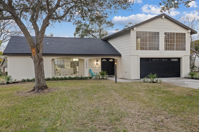 view of front facade with a front lawn and a garage