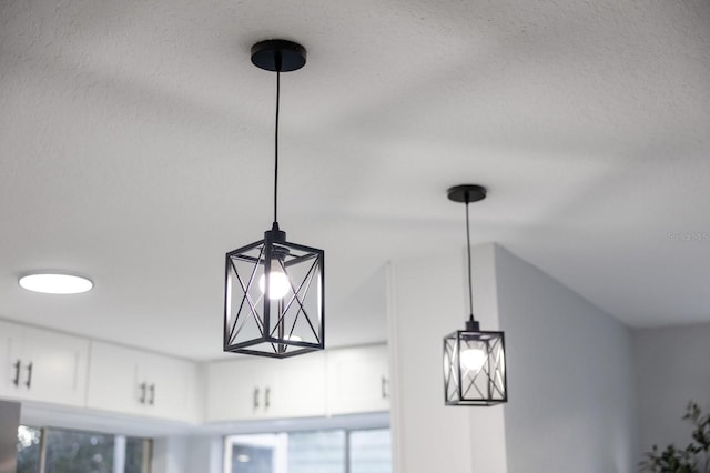 room details with decorative light fixtures and white cabinetry