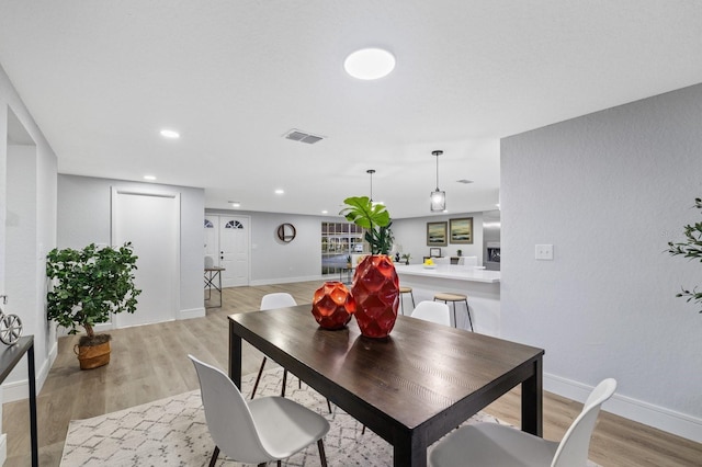 dining space with light wood-type flooring