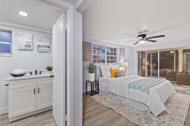 bedroom featuring ceiling fan, light wood-type flooring, and access to exterior