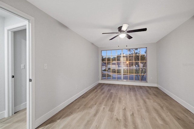 empty room featuring ceiling fan and light hardwood / wood-style floors