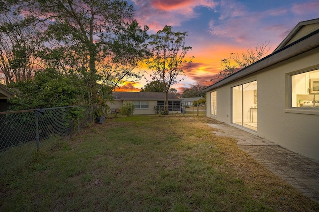 view of yard at dusk