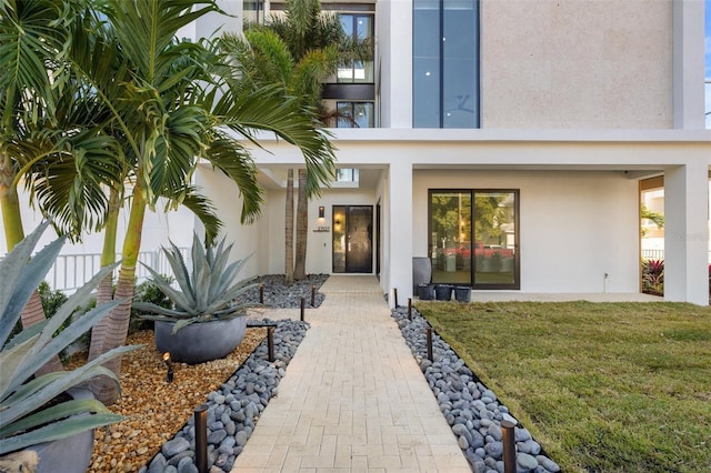 doorway to property with a yard