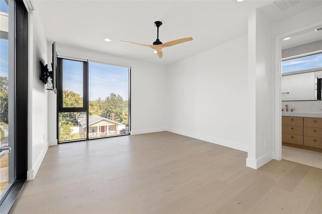 spare room featuring ceiling fan and light hardwood / wood-style flooring