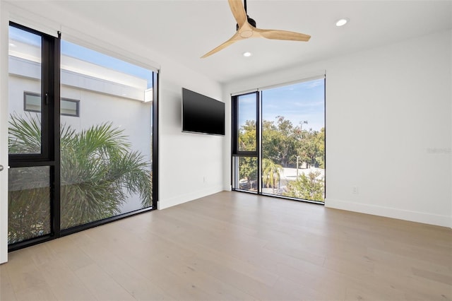 spare room featuring ceiling fan and light wood-type flooring