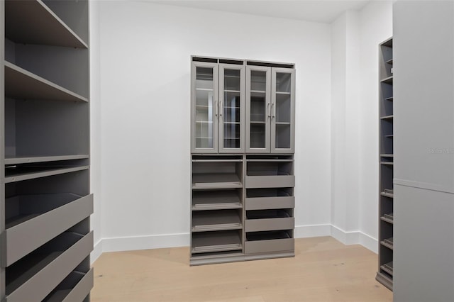 walk in closet featuring light hardwood / wood-style flooring