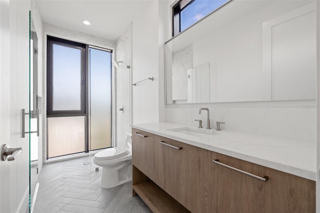 bathroom with toilet, an enclosed shower, and vanity