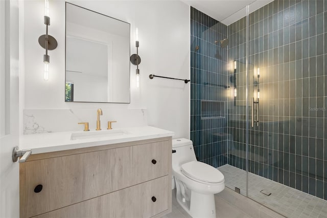 bathroom featuring an enclosed shower, vanity, and toilet