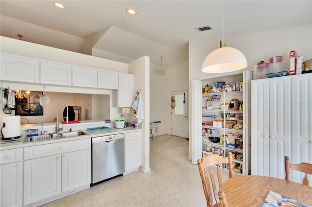 kitchen with white cabinetry, vaulted ceiling, pendant lighting, stainless steel dishwasher, and sink