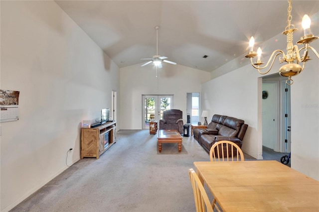 dining area with carpet floors, french doors, vaulted ceiling, and ceiling fan with notable chandelier