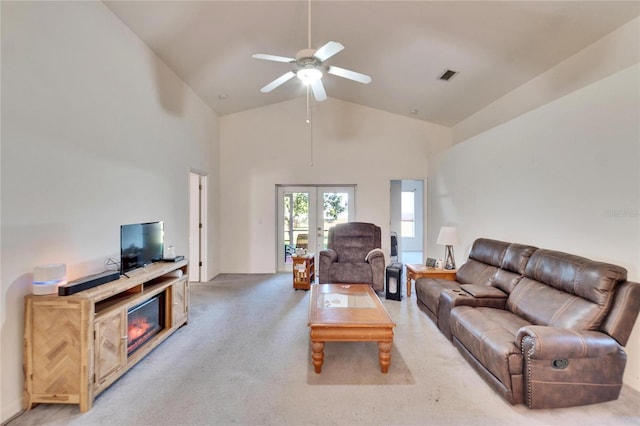 carpeted living room featuring ceiling fan, french doors, and high vaulted ceiling