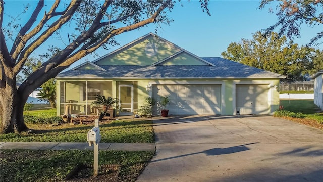 view of front facade featuring a garage and a sunroom