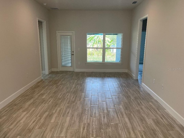 unfurnished room with light hardwood / wood-style floors