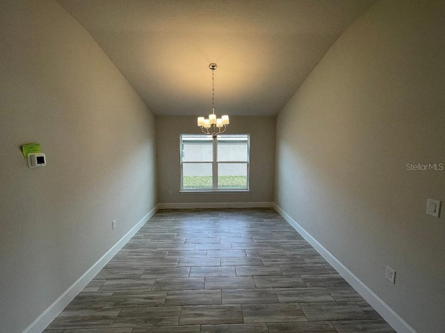 unfurnished dining area with a notable chandelier