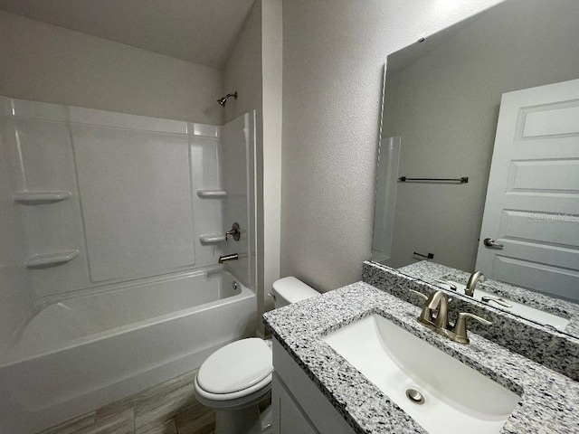 full bathroom featuring toilet, vanity,  shower combination, and hardwood / wood-style flooring