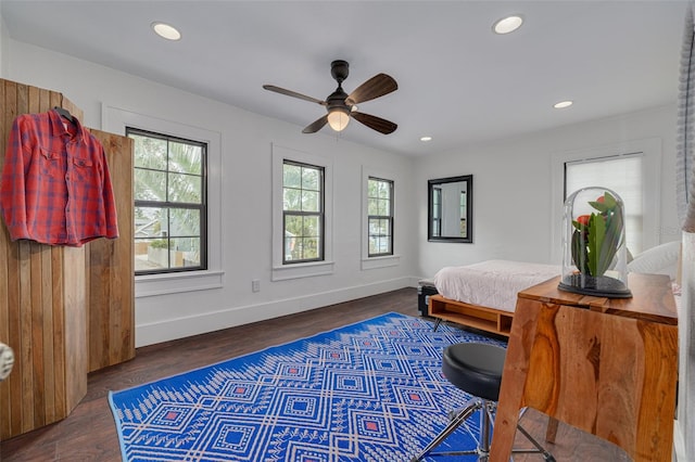 bedroom with ceiling fan, dark hardwood / wood-style floors, and multiple windows