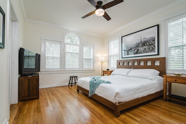 bedroom featuring light hardwood / wood-style flooring, ornamental molding, and ceiling fan