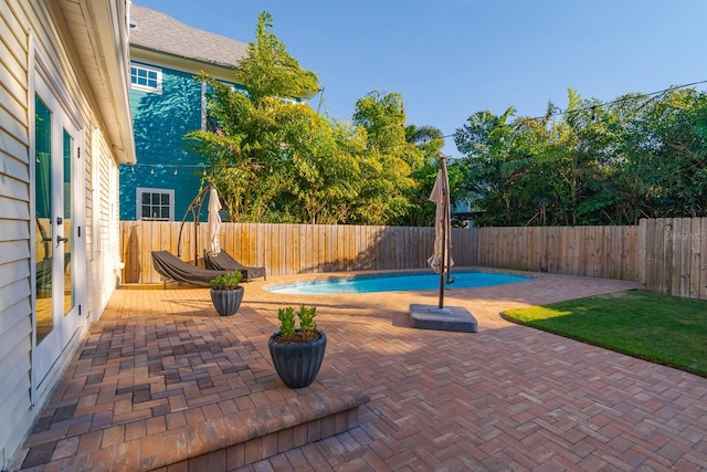 view of patio / terrace with a fenced in pool