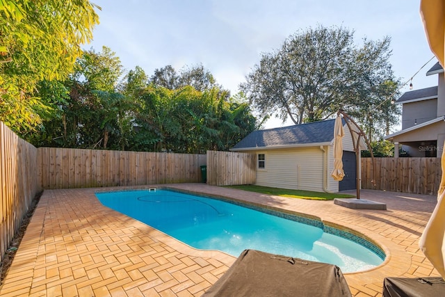 view of pool featuring a patio area and an outdoor structure