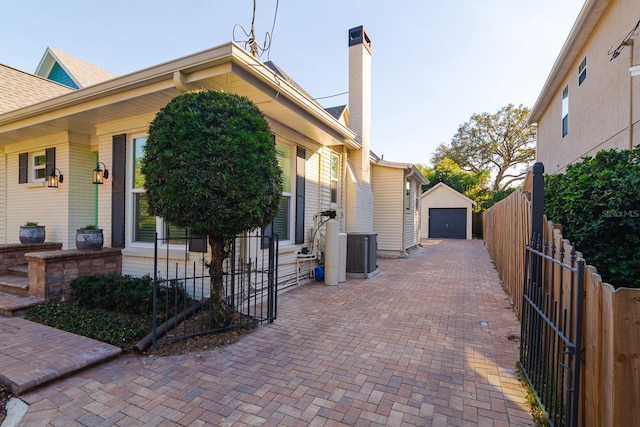 exterior space with an outbuilding, a garage, and central AC