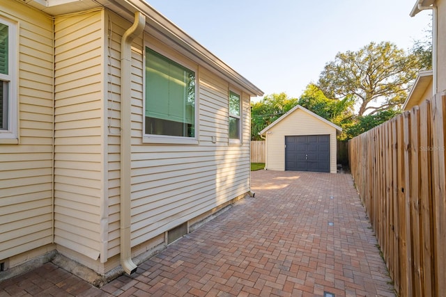 view of property exterior featuring a garage and an outdoor structure