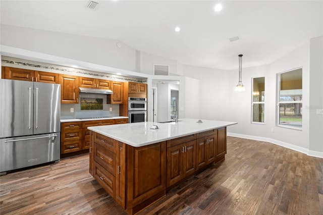 kitchen featuring a center island with sink, tasteful backsplash, appliances with stainless steel finishes, and pendant lighting