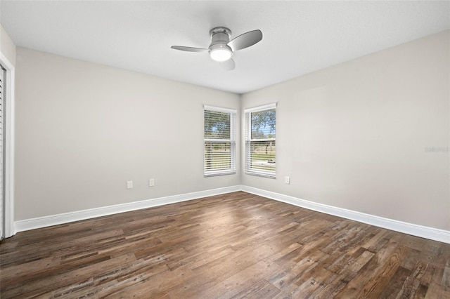 empty room with dark wood-type flooring and ceiling fan