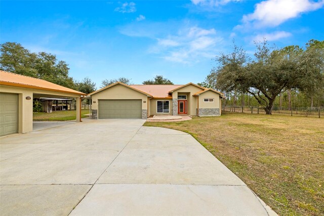 single story home with a garage and a front yard