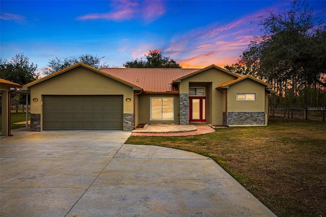 single story home with a yard and a garage