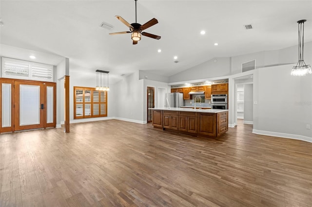 unfurnished living room with high vaulted ceiling, hardwood / wood-style floors, and ceiling fan