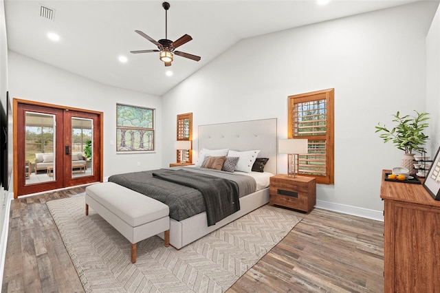 bedroom featuring multiple windows, light wood-type flooring, ceiling fan, and french doors