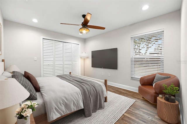 bedroom featuring wood-type flooring, a closet, and ceiling fan