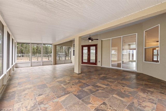 unfurnished sunroom featuring french doors and ceiling fan