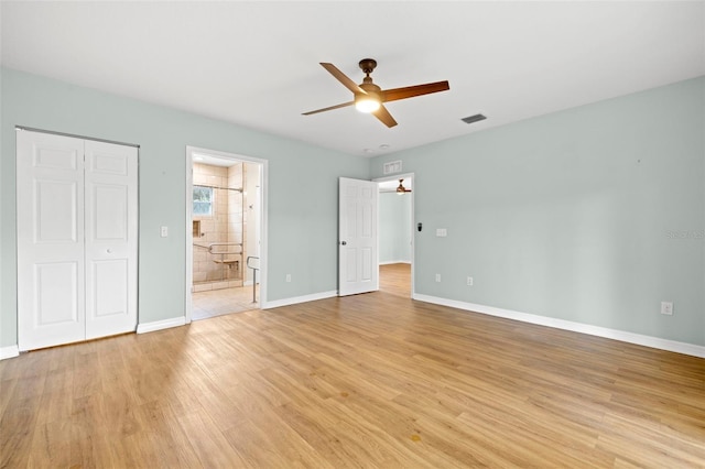 unfurnished bedroom featuring light wood-type flooring, ceiling fan, and ensuite bathroom