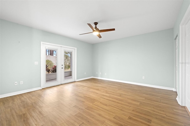 empty room featuring ceiling fan, light wood-type flooring, and french doors