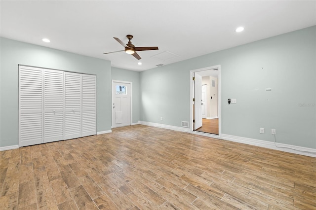 unfurnished living room featuring ceiling fan and light wood-type flooring