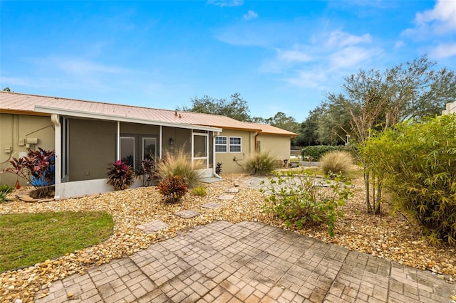 back of house with a sunroom