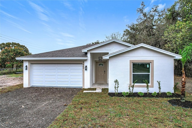 ranch-style home with aphalt driveway, roof with shingles, stucco siding, an attached garage, and a front lawn