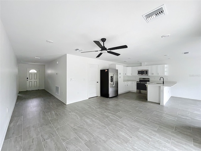 kitchen featuring open floor plan, appliances with stainless steel finishes, a sink, and visible vents