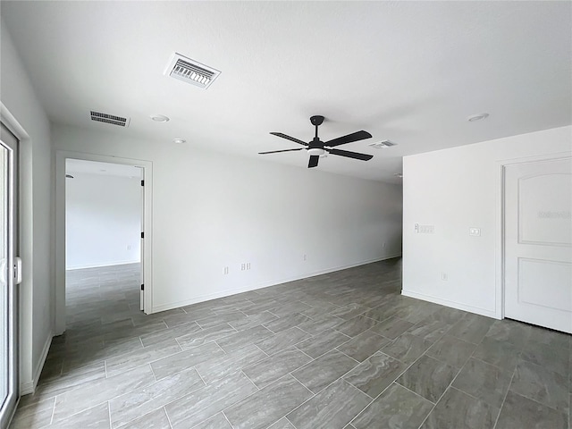 unfurnished room featuring a ceiling fan, visible vents, and baseboards