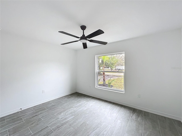 empty room featuring ceiling fan, wood finish floors, and baseboards