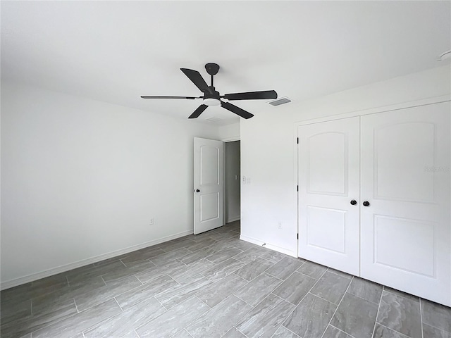 unfurnished bedroom with a ceiling fan, a closet, visible vents, and baseboards