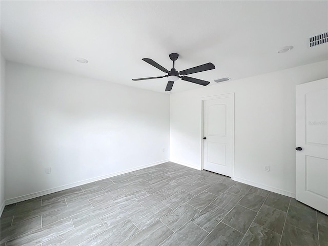 unfurnished room featuring ceiling fan, visible vents, and baseboards