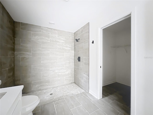 bathroom with vanity, a shower stall, and toilet