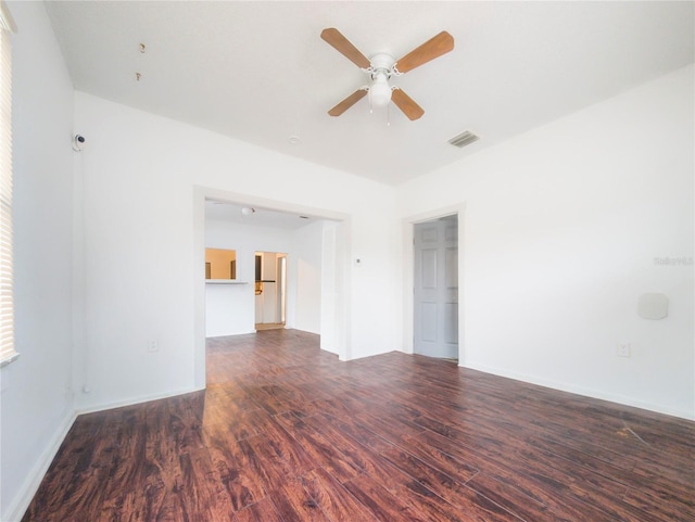 spare room featuring dark wood-type flooring and ceiling fan