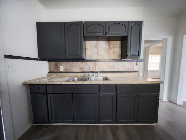 kitchen with backsplash, dark hardwood / wood-style flooring, and sink