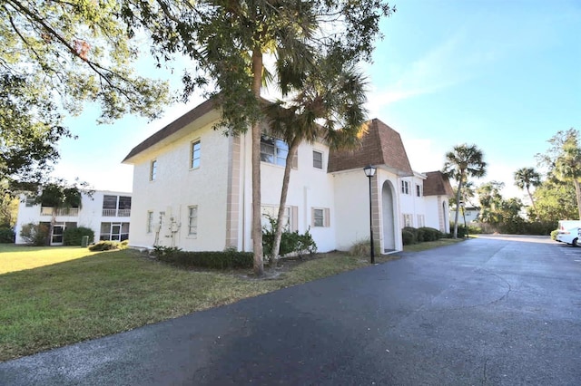 view of side of home with a yard